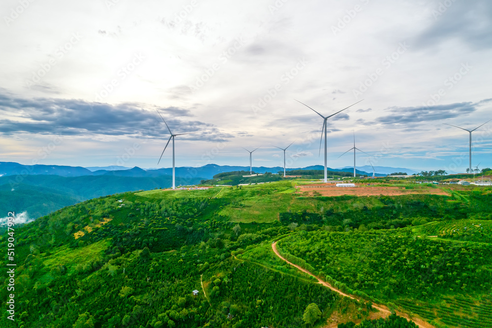 Wind turbines on the top of the hill in the morning. This is a clean energy source that does not pollute the environment to serve electricity for people Wind turbines on the top of the hill in the morning. This is a clean energy source that does not pollute the environment to serve electricity for people