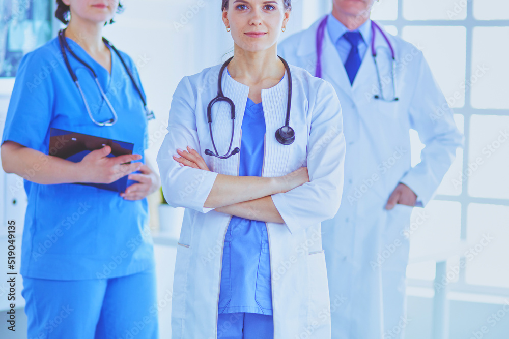 Group of doctors and nurses standing in the hospital room Group of doctors and nurses standing in the hospital room