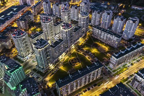 new high-rise apartment buildings in modern residential neighborhood. aerial view at night.