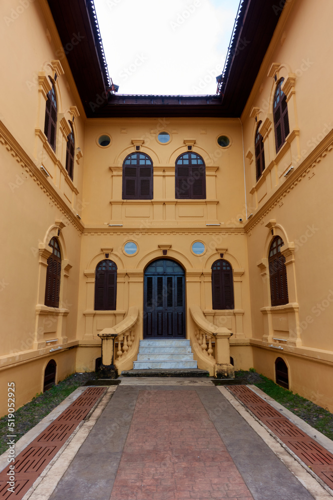 The ancient yellow building colonial architecture There are beautiful decorative stucco components, doors and windows.