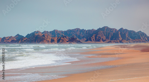 Fototapeta Naklejka Na Ścianę i Meble -  Namib desert with Atlantic ocean meets near Skeleton coast, Full moon in the background - Namibia, South Africa 