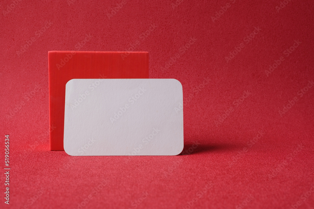 blank business card on pedestal on vivid red background studio blank business card on pedestal on vivid red background studio
