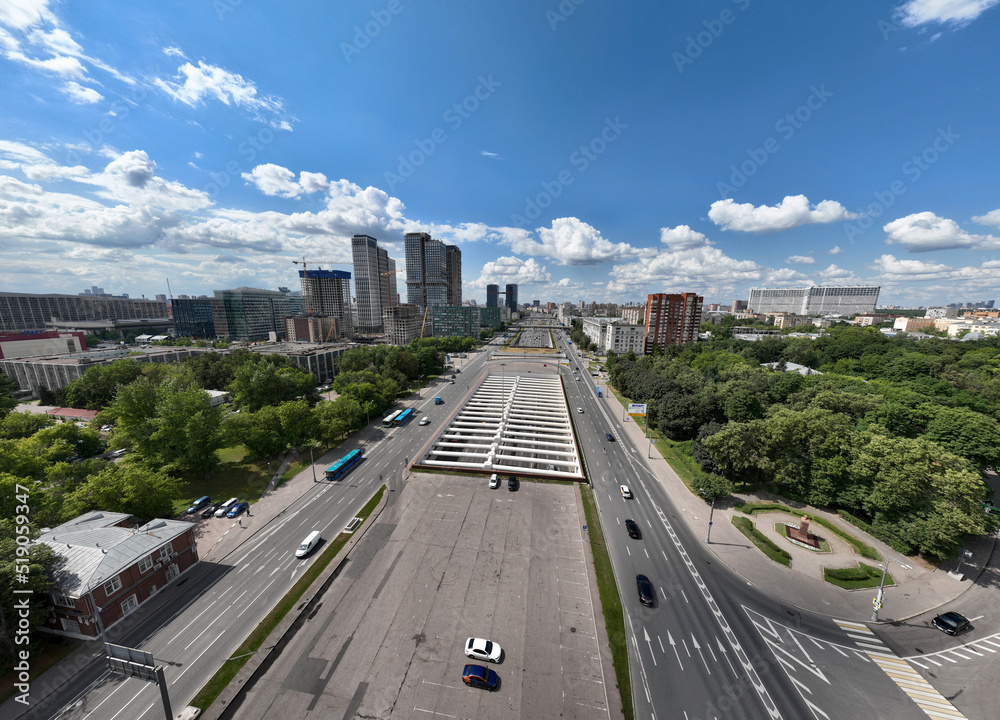 panoramic view of an automobile avenue with busy traffic in the center of Moscow on a sunny day taken from a drone