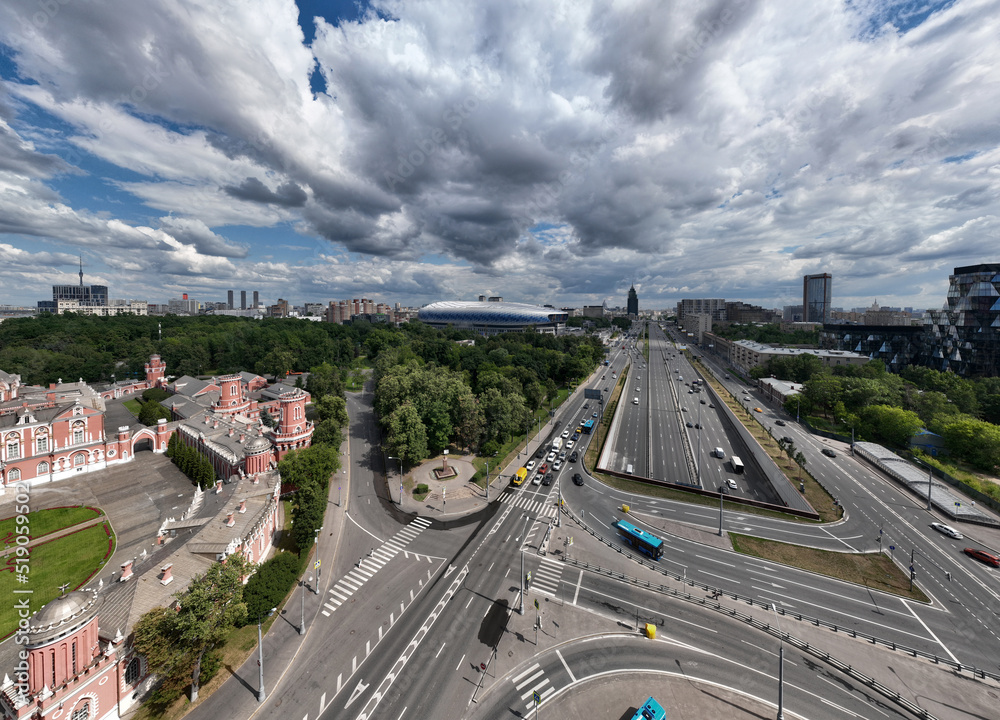Fototapeta premium panoramic view of an automobile avenue with busy traffic in the center of Moscow on a sunny day taken from a drone