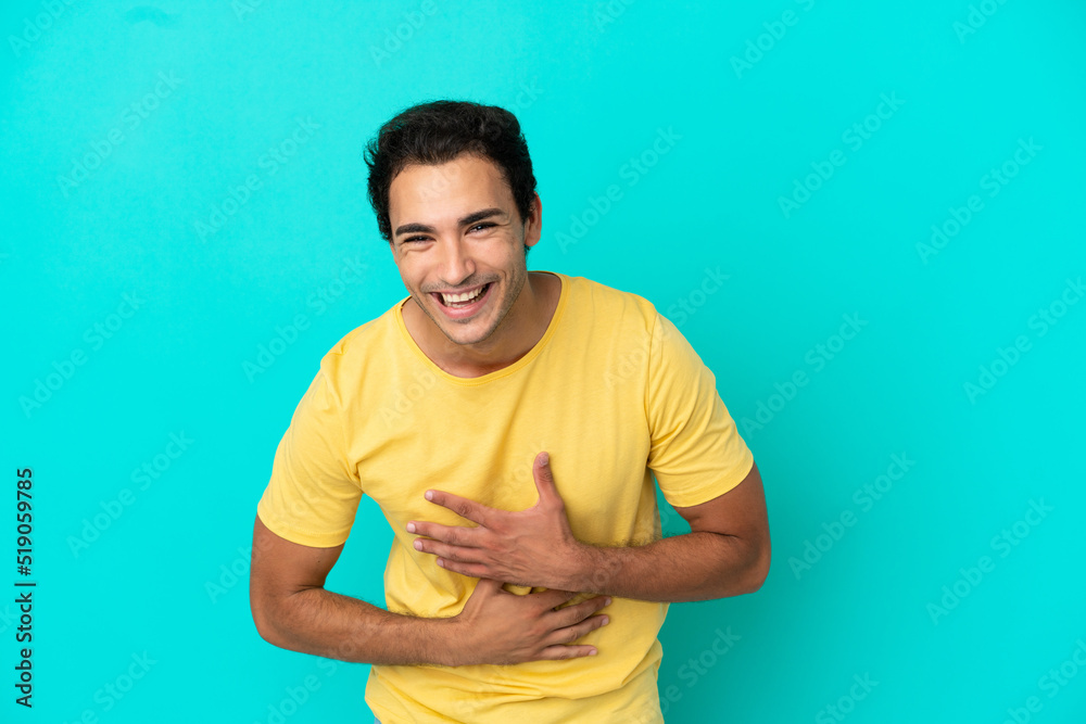 Caucasian handsome man over isolated blue background smiling a lot Caucasian handsome man over isolated blue background smiling a lot