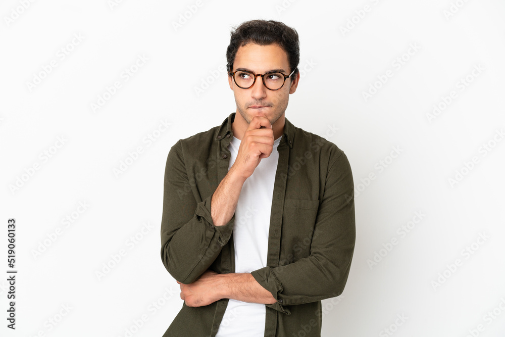 Caucasian handsome man over isolated white background having doubts and thinking Caucasian handsome man over isolated white background having doubts and thinking