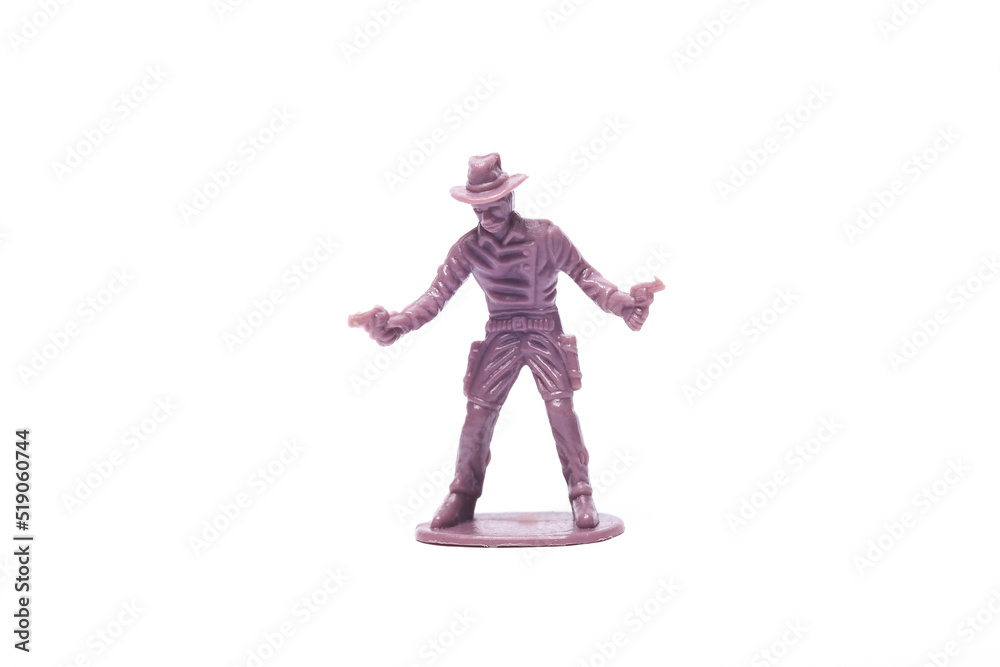 Plastic figurine of a cowboy with pistols on a white background Plastic figurine of a cowboy with pistols on a white background
