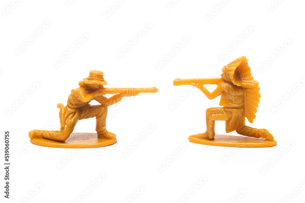 Wild West. Plastic figurines of a cowboy and a native american with guns exchange fire on white background Wild West. Plastic figurines of a cowboy and a native american with guns exchange fire on white background