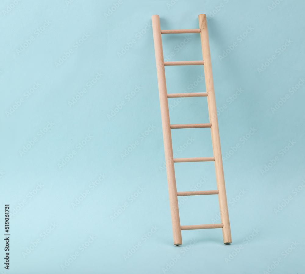 Wooden ladder on blue background. Minimum layout. Business, leadership concept, career growth