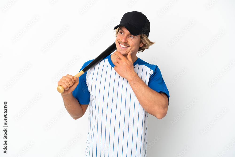 Young blonde man playing baseball isolated on white background looking to the side and smiling Young blonde man playing baseball isolated on white background looking to the side and smiling