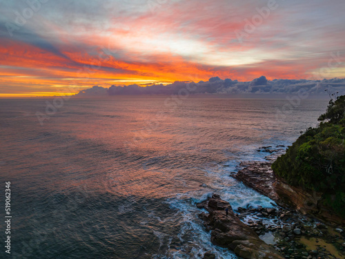 Sunrise over the sea with high cloud filled sky