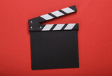 Movie clapper board without inscriptions on a red background