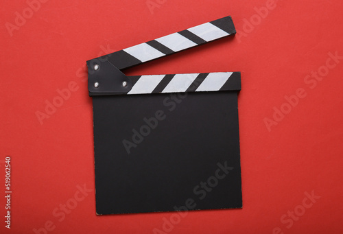 Movie clapper board without inscriptions on a red background photo