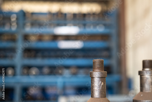 Wireline or Slickline (one kind of well service operation in oil field) general downhole tools are orderly keeping on metal shelve in the store. Selected focus on connection thread. photo