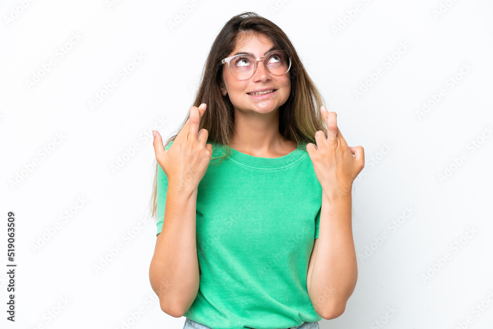 Young caucasian woman isolated on white background with fingers crossing and wishing the best Young caucasian woman isolated on white background with fingers crossing and wishing the best