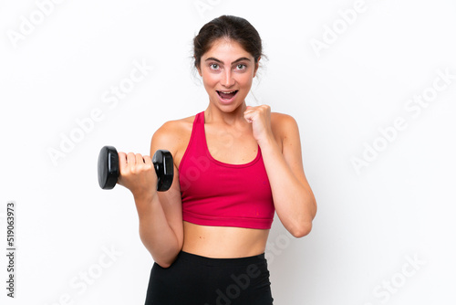 Young sport caucasian woman making weightlifting isolated on white background celebrating a victory in winner position