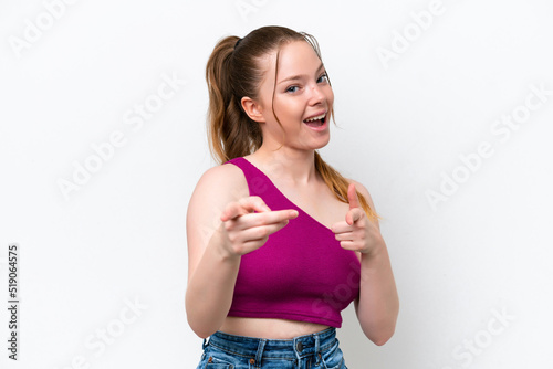 Young caucasian girl isolated on white background surprised and pointing front