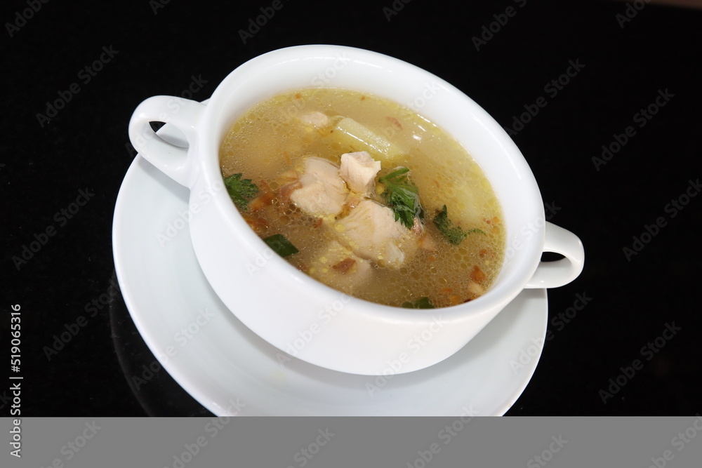 delicious and healthty chicken soup in a white bowl delicious and healthty chicken soup in a white bowl