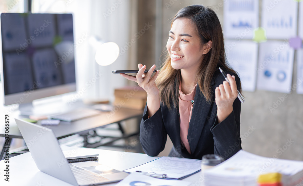 Young Business asian woman talking on smartphone and working in office. Asian female Business sitting at his workplace.