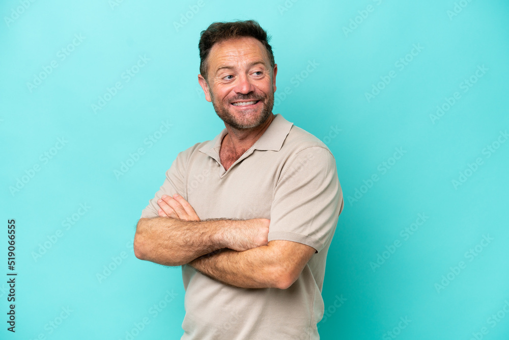 Middle age caucasian man isolated on blue background with arms crossed and happy Middle age caucasian man isolated on blue background with arms crossed and happy