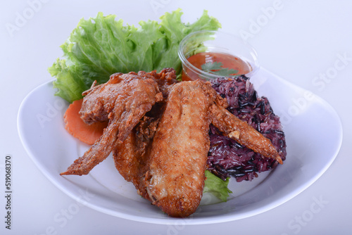 Fried chicken with sticky rice.  on white bowl for Thai food and isolate background 