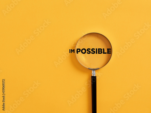 Magnifier focuses on the possible side of the word impossible. photo