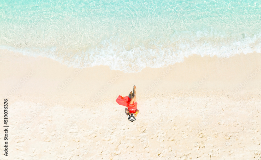 Beauty fashion in summer with woman body in bikini sunbathing as laying on the beach, blue sea water in background -Summer fashion concept,Top view Beauty fashion in summer with woman body in bikini sunbathing as laying on the beach, blue sea water in background -Summer fashion concept,Top view