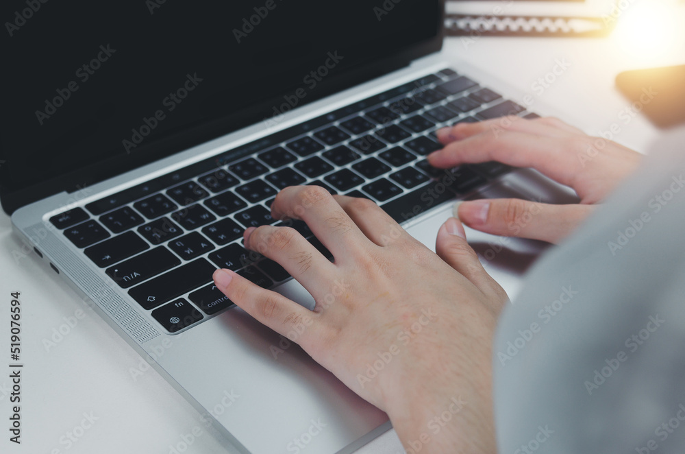 close up hand woman typing keyboard computer laptop on desk.Business technology online and communication on desk. close up hand woman typing keyboard computer laptop on desk.Business technology online and communication on desk.