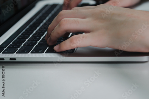 close up hand woman typing keyboard computer laptop on desk.Business technology online and communication on desk.