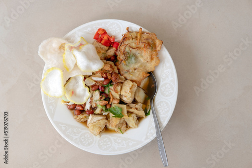 Kupat Tahu Magelang, Flat Lay with negatif space photo. It is a traditional Indonesian food made from fried ketupat, tofu, cabbage and bean sprouts, mixed with peanut sauce and soy sauce.