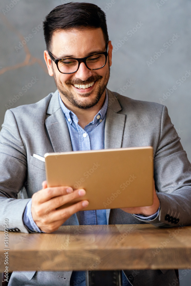 Portrait of young business man working on digital tablet Portrait of young business man working on digital tablet