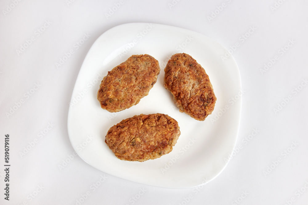 Fried meatballs on a white plate.