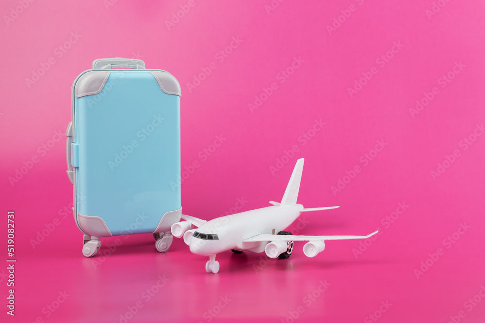 air tickets, passenger flights by airplane, air transportation, plane,  suitcase for luggage on a pink background Stock-Foto | Adobe Stock