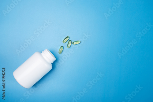 omega 3 capsules, fish oil, vitamin d on a blue medical background