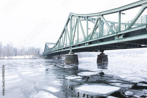 Germany, Brandenburg, Potsdam, Ice floating in river Havel withGlienickeBridge in background photo