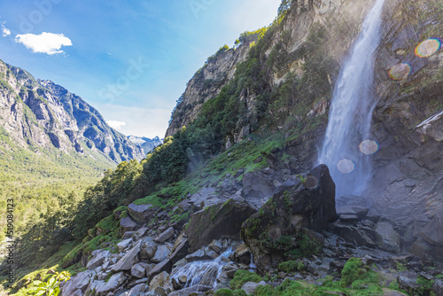 Foroglio waterfall splashing on rocks in valley photo