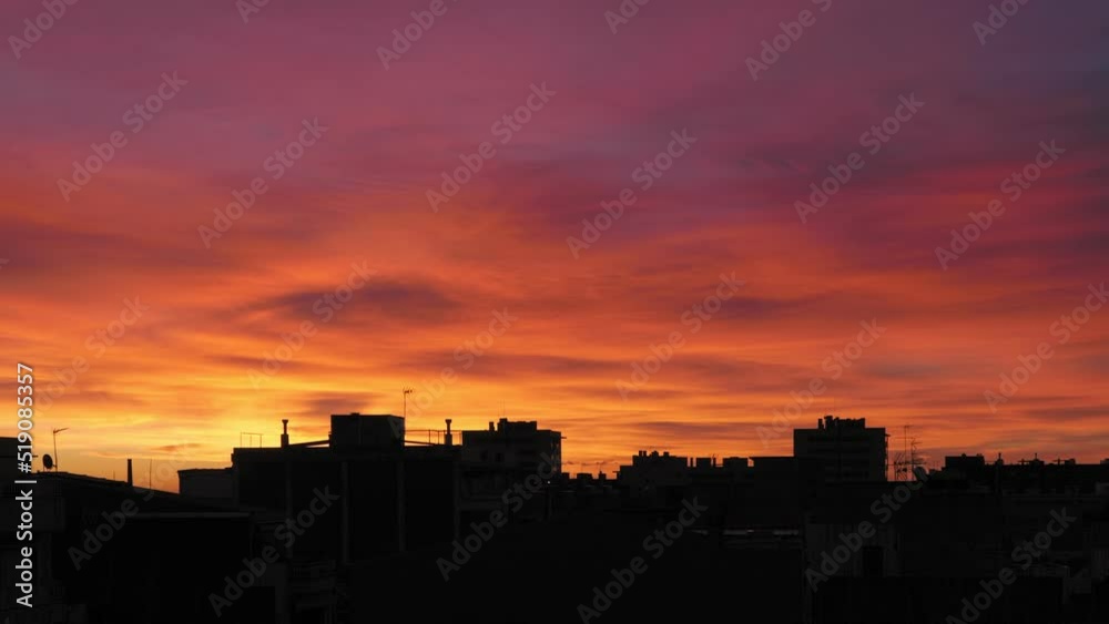 Golden sunrise over the city. Roofs of buildings against the background of colorful sky. Golden sunrise over the city. Roofs of buildings against the background of colorful sky.