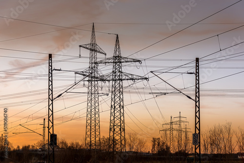 Power grid High power electricity poles in the sunset. Energy supply, distribution of energy, transmitting energy, energy transmission, high voltage supply.