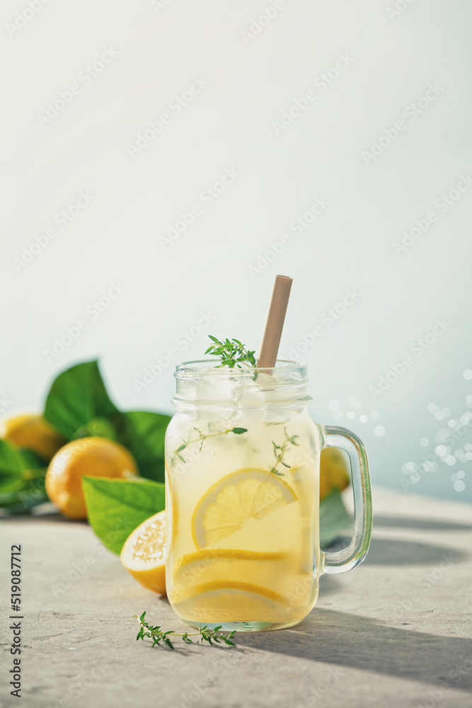 Fototapeta premium Lemonade with ingredients close up. Summer drinks and vacation concept. Sunny day shadows