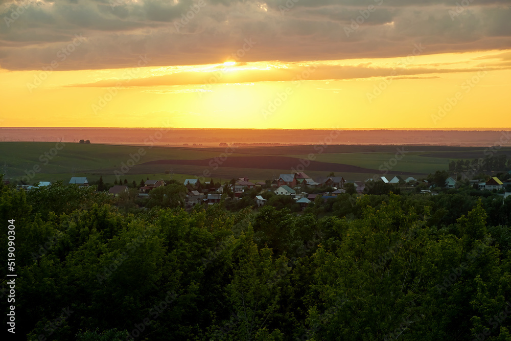Panoramic view of the sunset over the valley and the village. Landscape and nature backgrounds