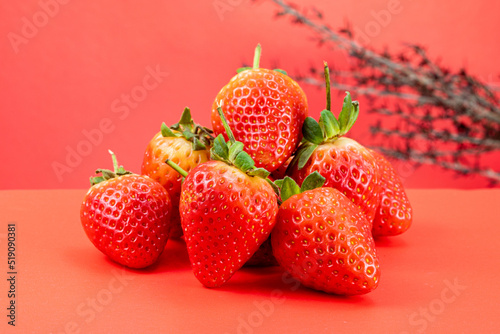 Strawberry isolated in red background 