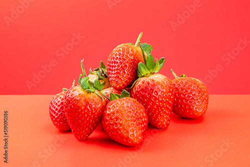 Strawberry isolated in red background 