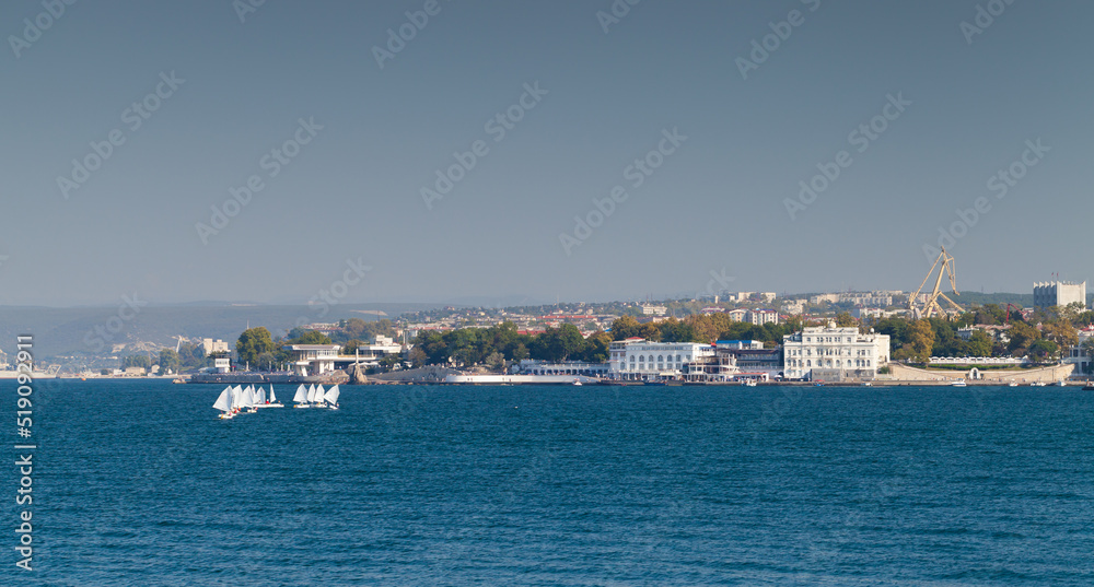 Coastal landscape of Crimea. Small training sailing boats