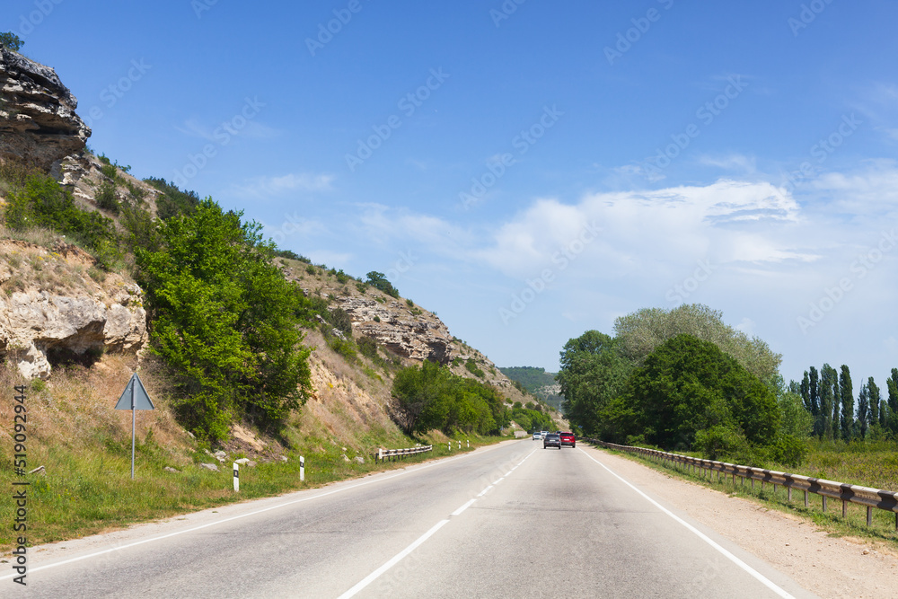 Summer landscape with cars on a mountain highway