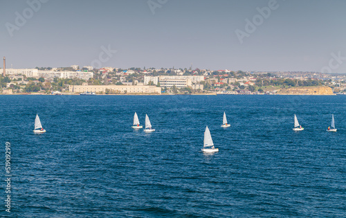 Small training sailing boats sail the bay of Sevastopol