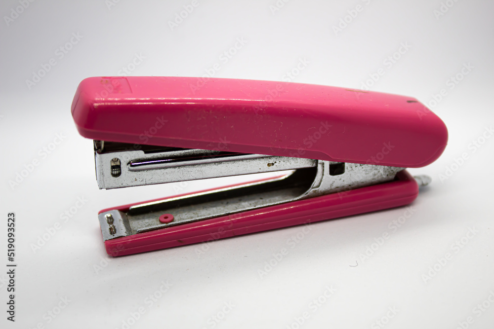 isolated pink stapler with selected focus on white background isolated pink stapler with selected focus on white background