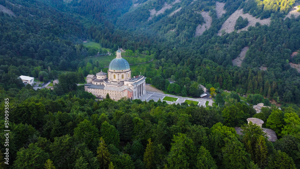 Aerial view of The Sanctuary of Oropa, Roman Catholic building in the Biellese Alps, Northern Italy. Tourist attraction and famous place of pilgrimage in Piedmont. Drone photography.