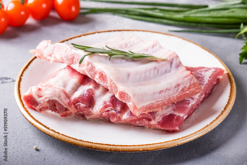 Raw pork ribs on a plate.