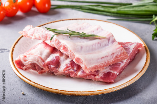 Raw pork ribs on a plate.