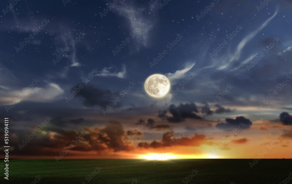 orange dramatic sunset on wild field sun down and moon rise on starry cloudy  sky green grass nature landscape